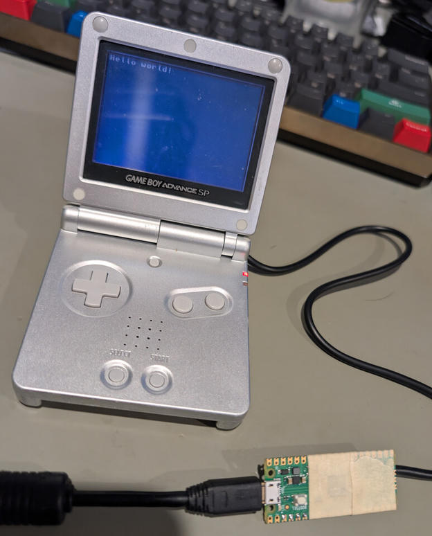Game Boy Advance SP displaying Hello world! from a test ROM sent through the Pico multiboot cable