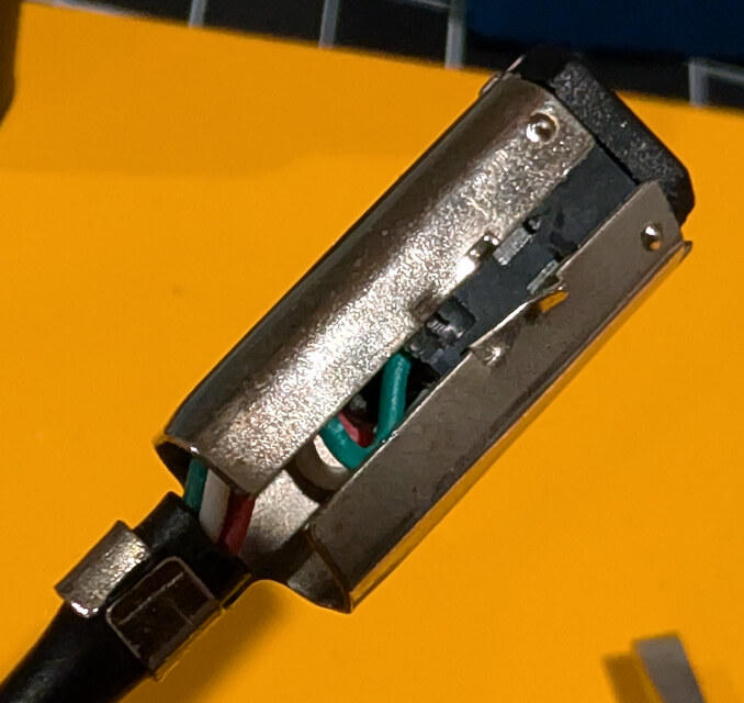 Prying open the metal shell around the GBA link connector
