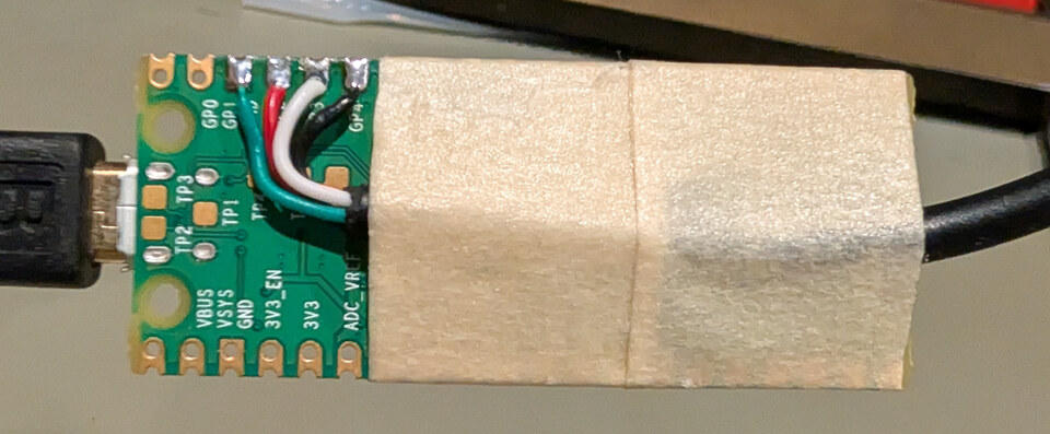 Four cable wires soldered to the Pico, with tape holding the cable against the board